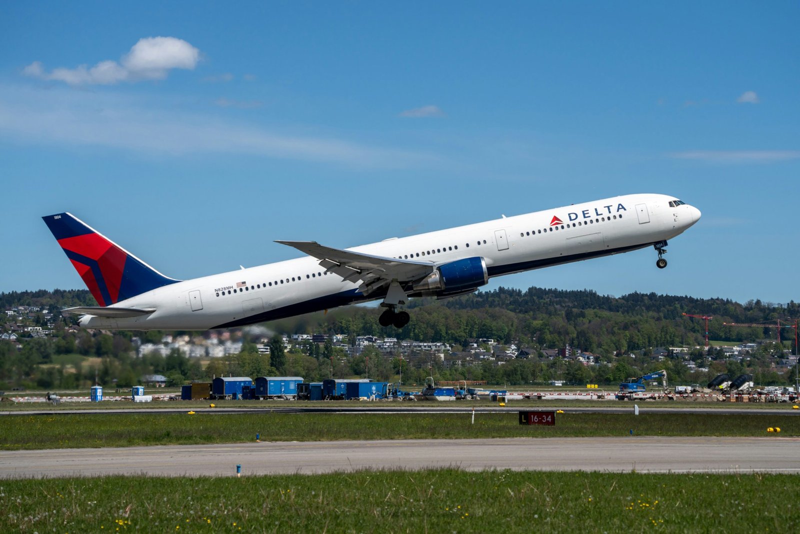 a delta airplane taking off from an airport runway